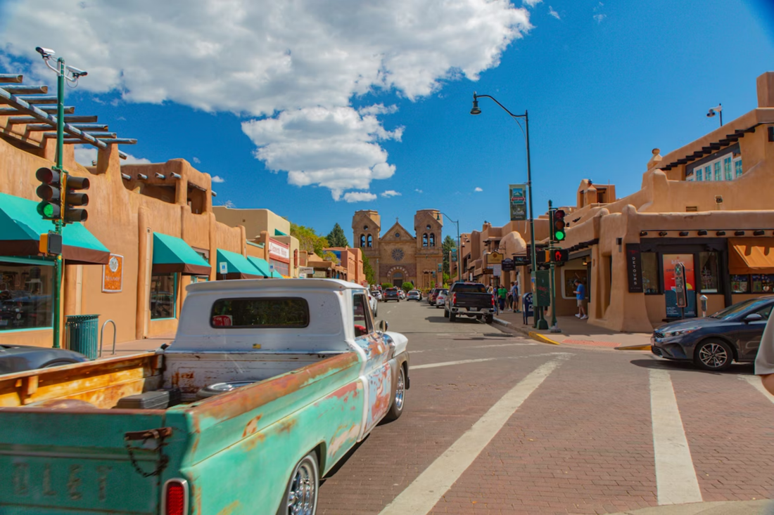 Santa Fe New Mexico Plaza adobe buildings with shops and blue sky – local guide by Milagro Goat Farm